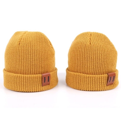 La toppa di cuoio tricotta i cappelli del Beanie progetta i cappelli per il cliente caldi del Beanie di giallo del cappuccio del cappello