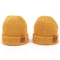 La toppa di cuoio tricotta i cappelli del Beanie progetta i cappelli per il cliente caldi del Beanie di giallo del cappuccio del cappello